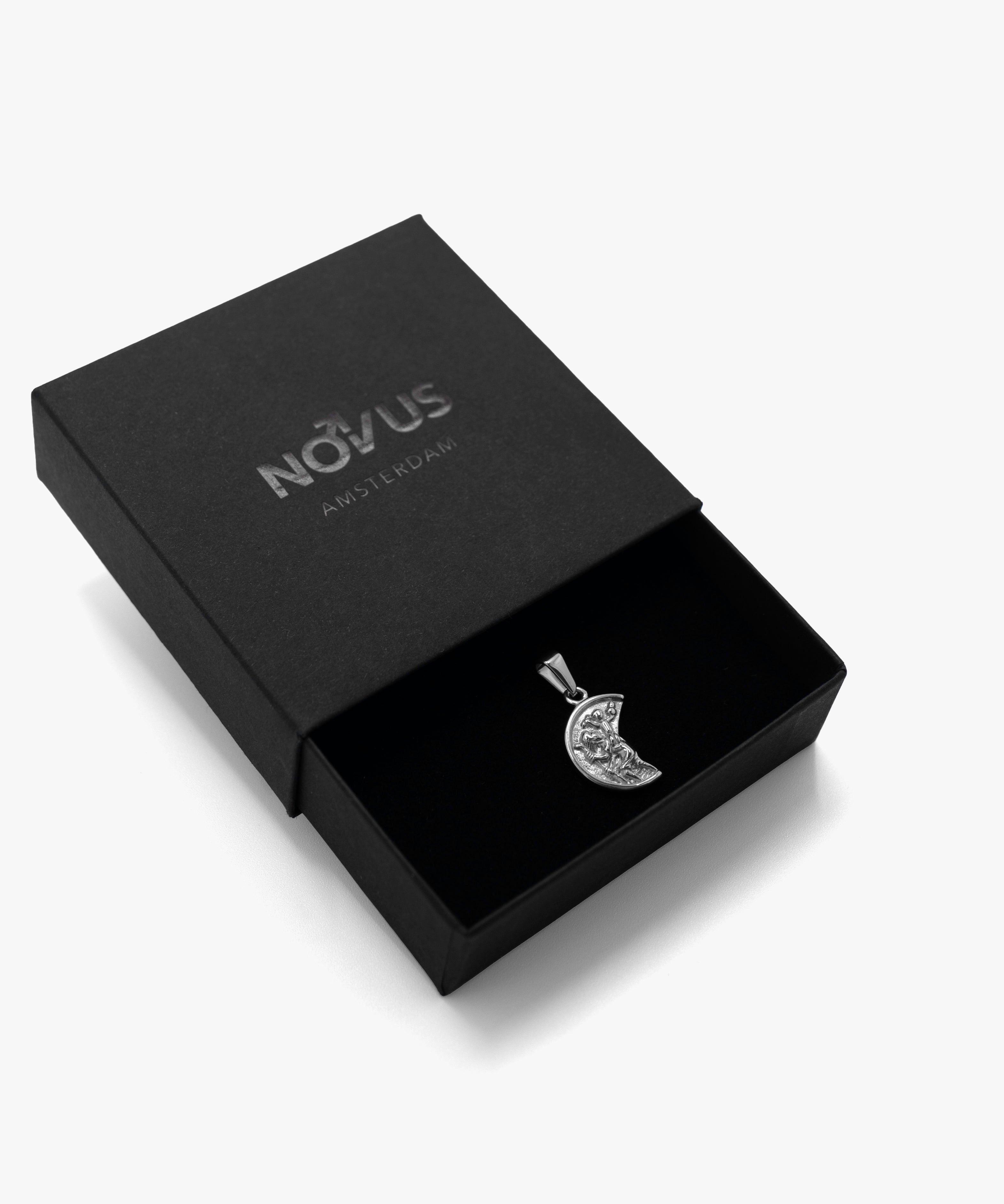 Silver broken coin pendant in jewelry box, from NOVUS Amsterdam